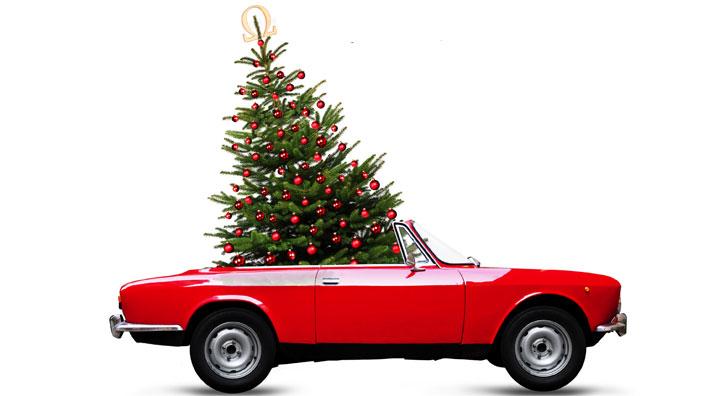 Red convertible carrying Christmas Tree
